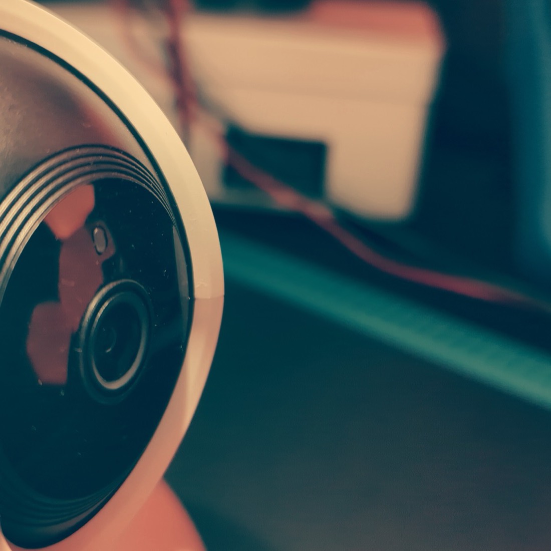 Consumer pan-tilt IP camera on the lab bench with a multimeter in the background